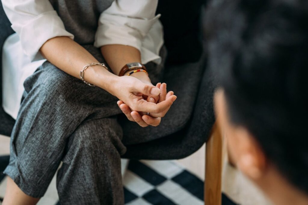 Hands held during a counseling conversation